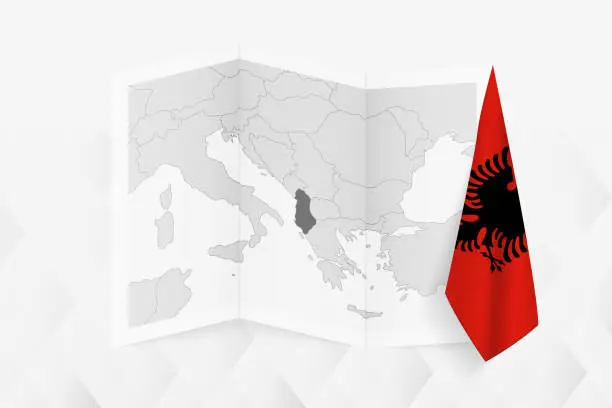 Vector illustration of A grayscale map of Albania with a hanging Albanian flag on one side. Vector map for many types of news.