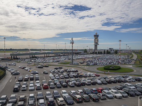 Milano, Italy - 8 august 2023: Car Parking and Airport Control Tower, Milan Malpensa Airport -Italy.