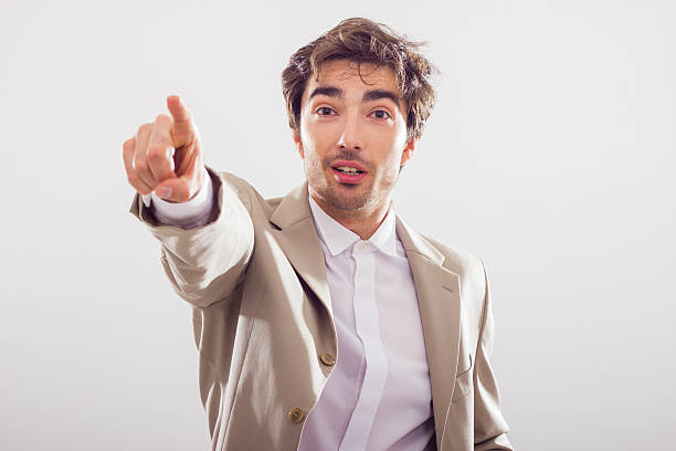 istock Handsome businessman pointing, looks surprised. 173378531