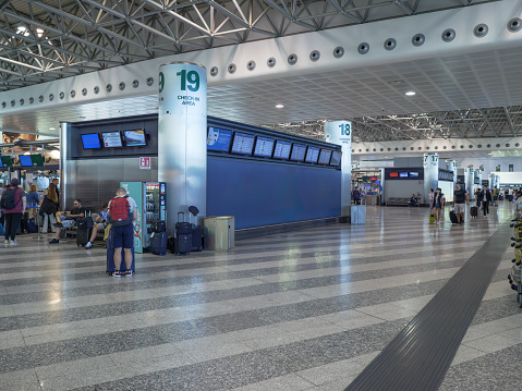 Milano, Italy - 8 august 2023: Check-in Area with Passengers Inside the Milan Malpensa Airport Facility in Italy