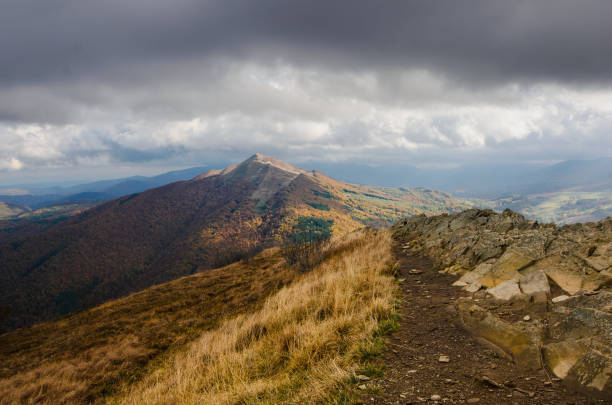Autumn in the mountains. Meadows and mountains. Gold colored grassland. View from Wetlinska Polonina to Carynska Polonina.