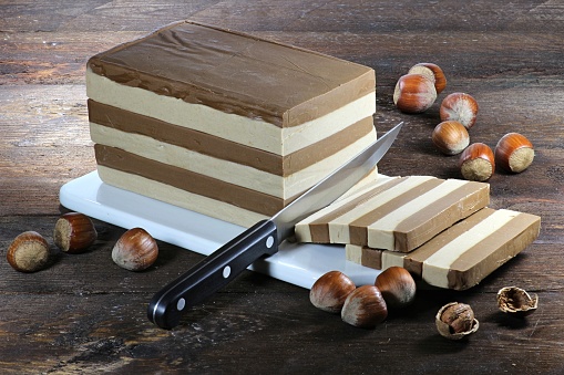 layer nougat cake on wooden background