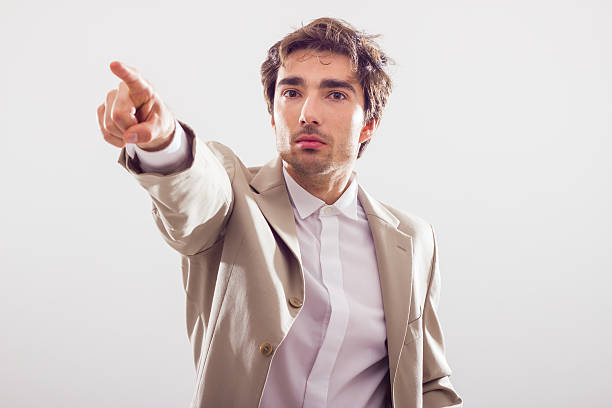 Handsome businessman pointing, looks angry stock photo
