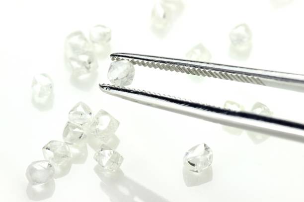 istock rough diamond held by tweezers 1733814860