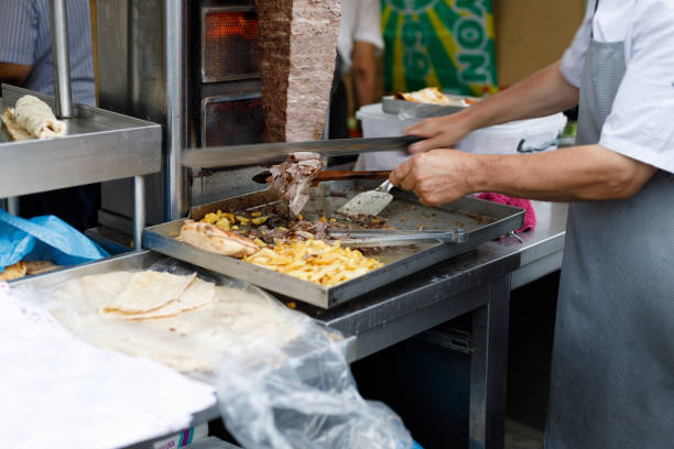 istock Shawarma seller cuts chicken meat from a spit 1733832954