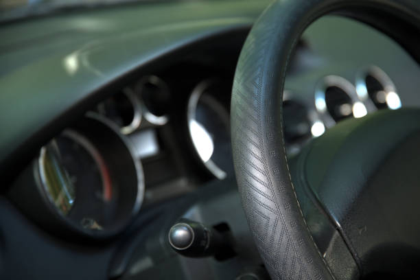istock Car steering wheel and blurred cockpit in background 1733834060