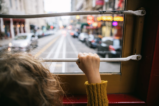 Girl Riding Cable Car In San Francisco