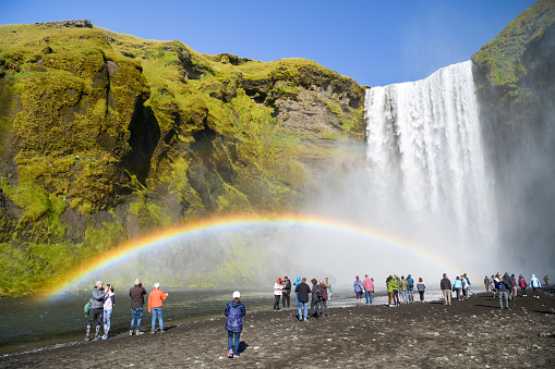 Skogar, Iceland - September 5, 2022: Tourists enjoying their time near Skogafoss waterfall in Iceland during sunny day in September 2022