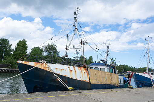 Old fishing vessel in port for repairs and paint