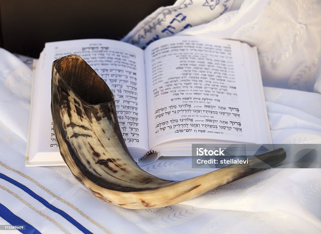 Shofar and prayer book Shofar and Hebrew prayer book on a Talit (prayer Shawl). Yom Kippur Stock Photo