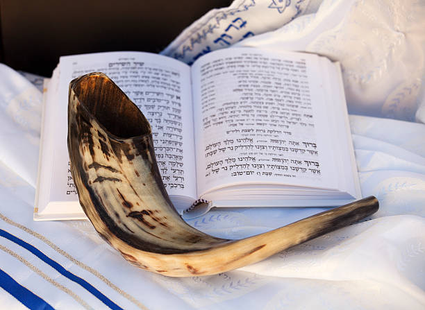 Shofar and Hebrew prayer book on a Talit (prayer Shawl).