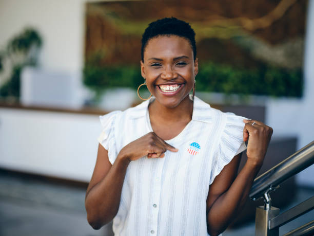 istock Woman in an Office with I VOTED Sticker 1733910826