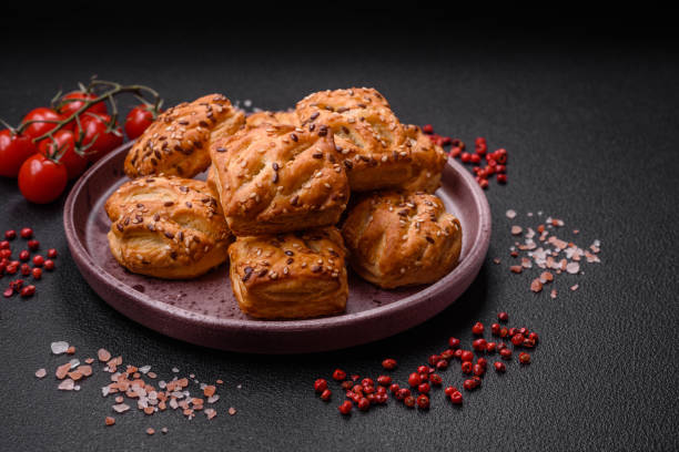 Delicious crispy mini puffs with sausage or meat with salt, thyme and sesame