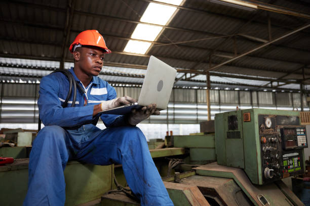 istock male african workers or technician using laptop computer on machine in the factory 1733914502