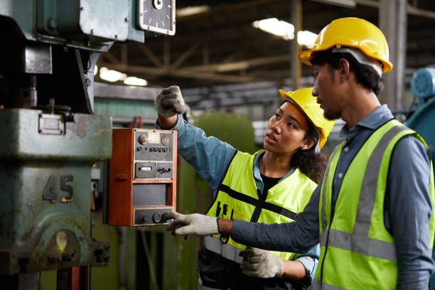 istock worker or engineer training and teaching how to use machine control with coworker in factory 1733914509