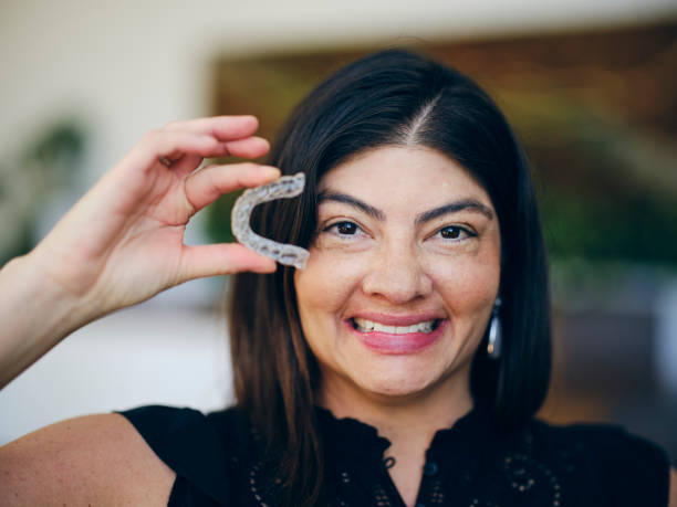 istock Woman Holding Dental Teeth Aligner 1733915084
