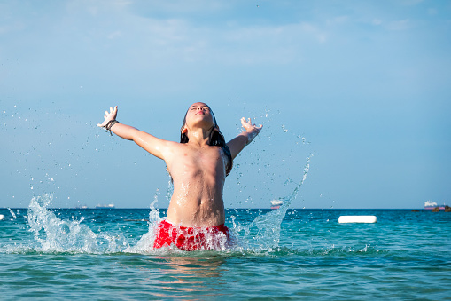 Photo of a young man getting ready for some serious swimming in the sea