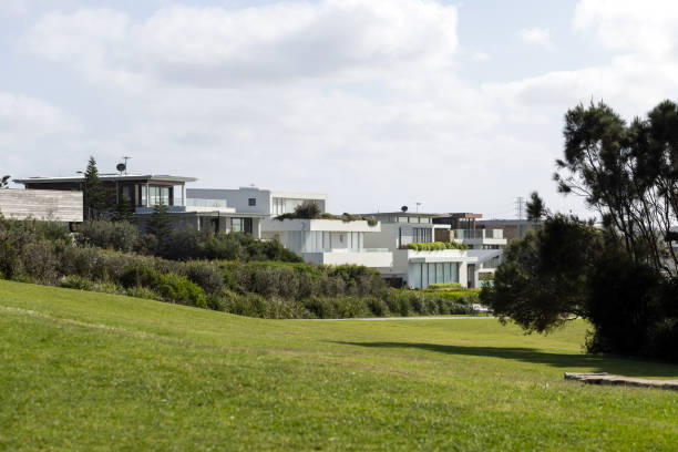 View through grass field to the new suburb, background with copy space, horizontal composition