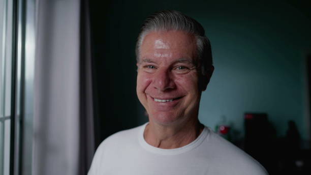 istock Smiling middle-aged man in his 50s looking at camera with happy expression. Portrait face close-up of person 1734008498