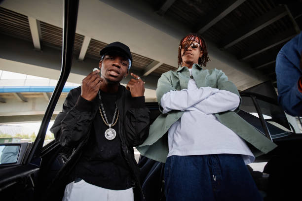 istock Young African American man in cap and black bomber jacket and his buddy 1734008807
