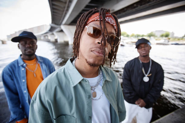 istock Young African American man with dreadlocks and headband looking at camera 1734009064