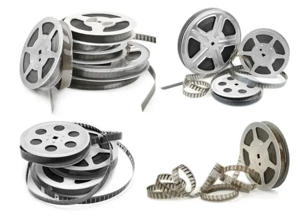 Photo of Collections old film strip in metal bobbins isolated on white. Various angles.