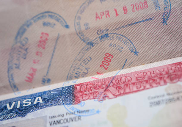istock Immigrant passport with American visa and stamps. 1734016680
