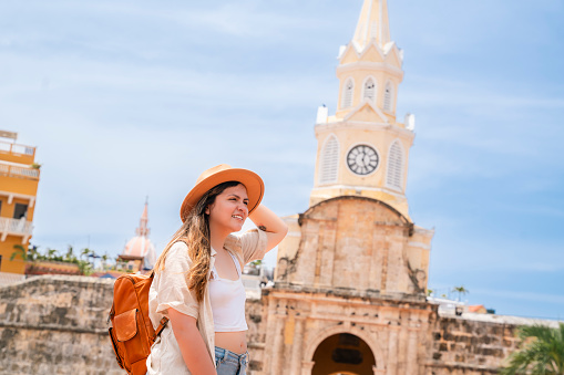 A Traveling Woman in a leather backpack explores the tropical and wonderful Cartagena