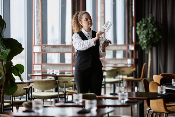 istock Server polishing glasses in restaurant preparing for opening 1734020006