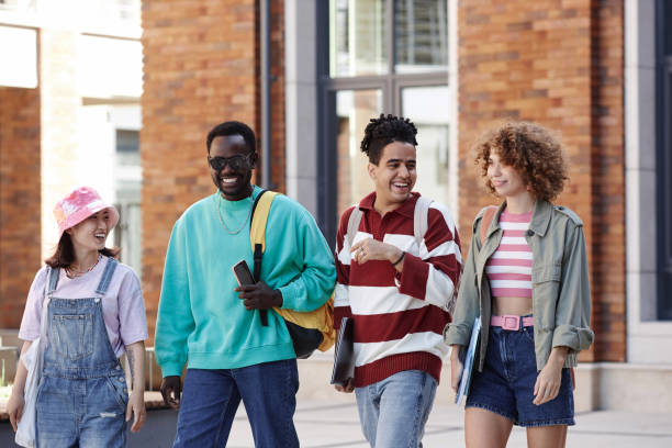 istock Multiethnic group of young students walking in row together and smiling 1734030279