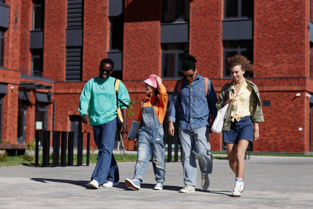istock Multiethnic group of young students walking together outdoors 1734030875
