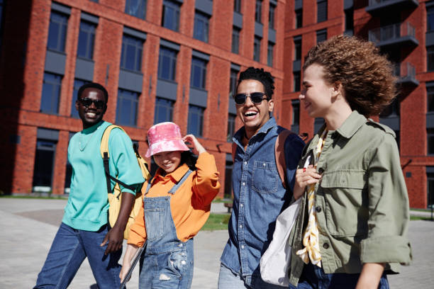 istock Young people walking together outdoors on modern college campus 1734030883