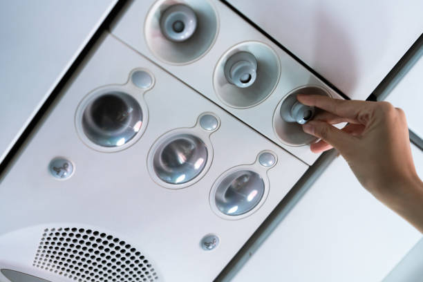 human hand Turning on the air flow in the airplane