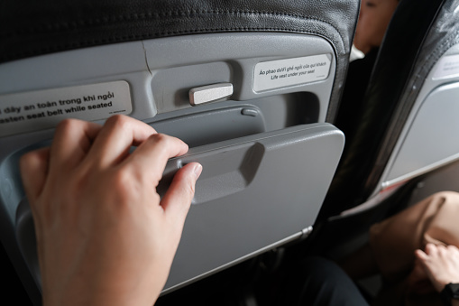 Woman Hand Close Airplane Tray Table