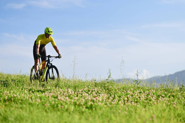 istock bicyclist enjoying bicycle ride in a meadow. 1734061229
