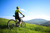 rear view of a mountain biker looking at panorama.