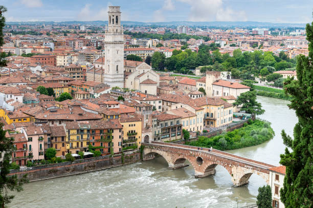 Embankment of Adige River with Ponte Pietra bridge Verona, Italy-June 13, 2023; High level panoramic view over the city along the embankment of Adige River with Ponte Pietra bridge and Cattedrale di Santa Maria Matricolare verona opera stock pictures, royalty-free photos & images