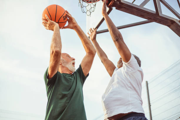 istock Two Diverse Senior Friends Having a Friendly Basketball Match 1734076218