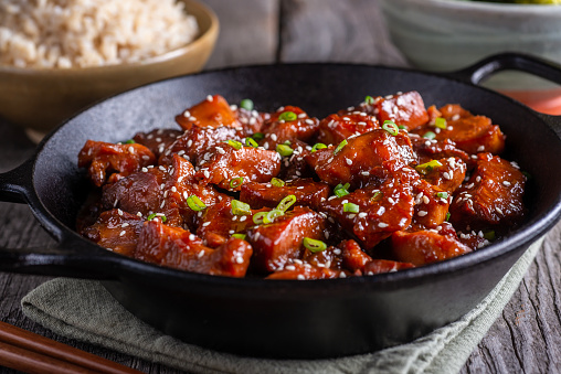 Sesame Chicken in a Wok with Rice and Broccoli