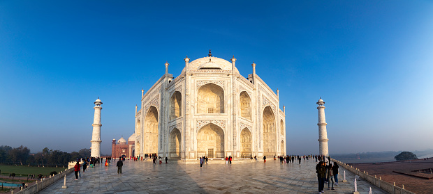 Agra, India - October 11, 2016: Facade view of Taj Mahal in Agra, India. It was commissioned in 1632 by the Mughal emperor, Shah Jahan (reigned 1628–1658), to house the tomb of his favourite wife, Mumtaz Mahal.