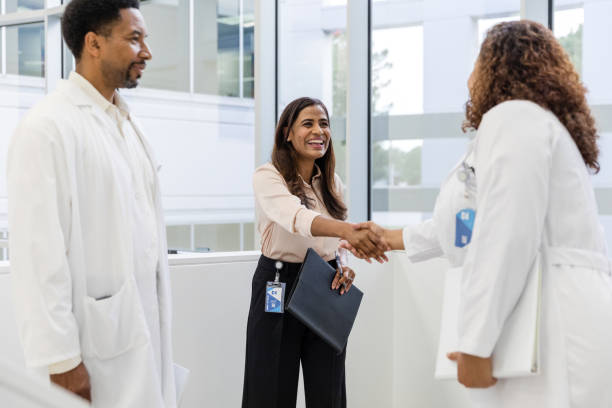 istock Female pharmaceutical representative smiles and introduces herself to the physician 1734158897