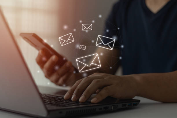 istock email marketing and correspondence communication technology concept. Corporate send letter invitation, social media. Business people using laptop PC, mobile phone with mail icon, open digital message. 1734168088