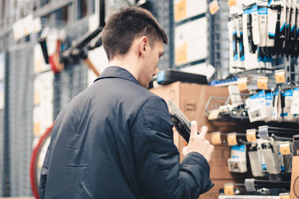 istock A young man inspects goods in a store. 1734214012