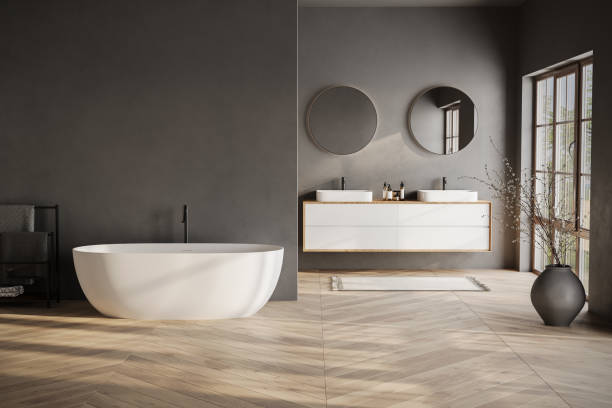 istock Modern bathroom interior with dark walls, marble basin with double mirror, bathtub, parquet floor. Minimalist black bathroom with modern furniture 1734218314
