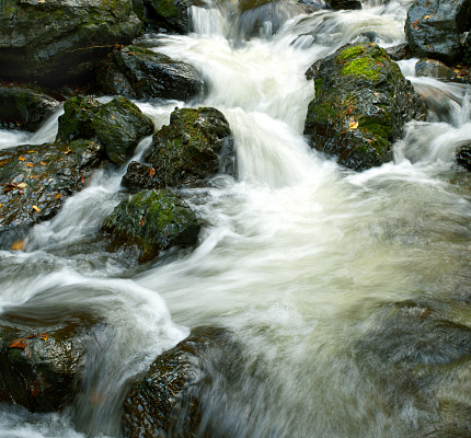 Beautiful splashing waterfall in moss stones mountain landscape