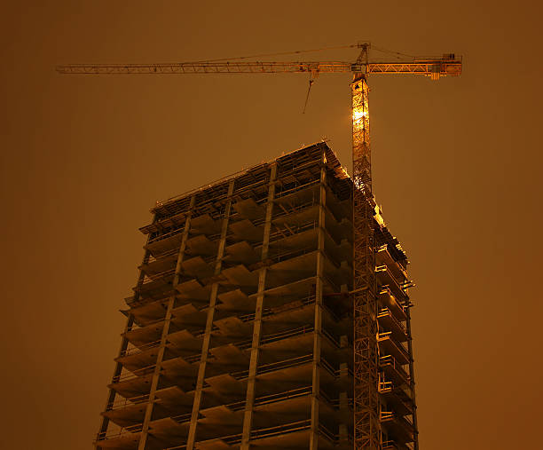 Building under construction with crane stock photo