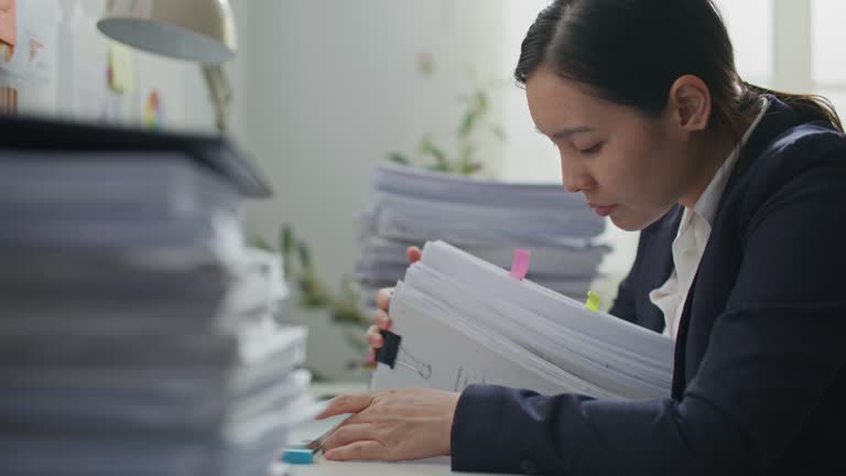 Businesswoman hands working on Stacks of documents files for finance in office