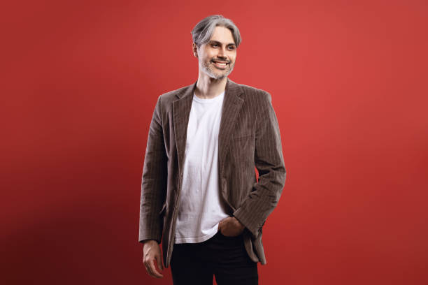 istock man smiling with hand in pocket and looking to the side 1734280805