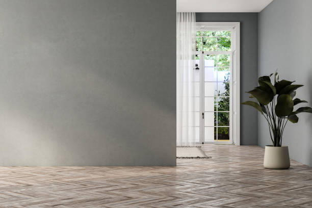 istock empty living room with gray tones walls, windows and yard. 1734285643