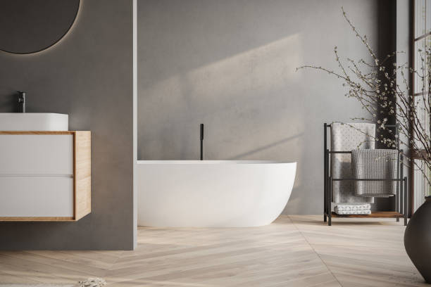 istock Modern bathroom interior with dark walls, marble basin with double mirror, bathtub, parquet floor. Minimalist black bathroom with modern furniture. 1734289860